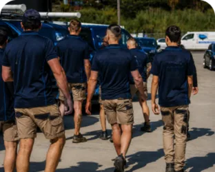 Plumbers walking to their service vans on a Eastwood job